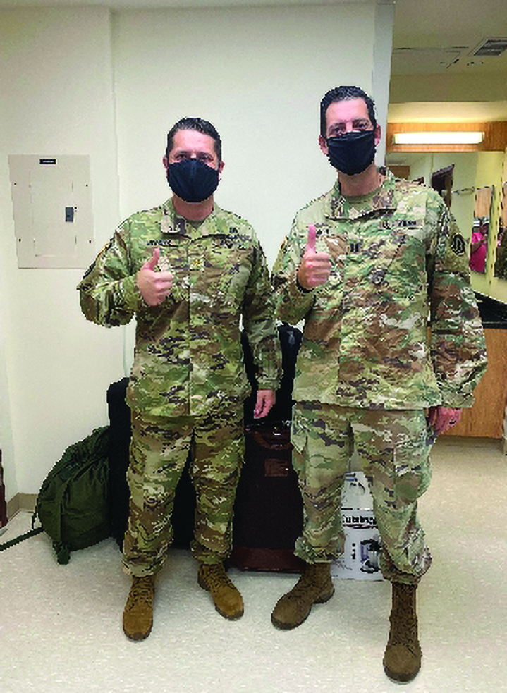 MAJ Justin R. Wegner, Brigade Judge Advocate, 2BCT, 1st Infantry Division, USFK Korea, and CPT Michael W. Leach, Deputy Brigade Judge Advocate, 658th Regional Support Group, 9th Mission Support Command, emerge from 15 days of isolation in quarantine barracks, an experience they shared with two other barracks-mates on Camp Humphreys, South Korea. MAJ Wegner will serve in Korea on a rotation with the 1st Infantry Division while CPT Leach will perform operational support and military justice duties on Camp Humphreys for the 658th Regional Support Group. 